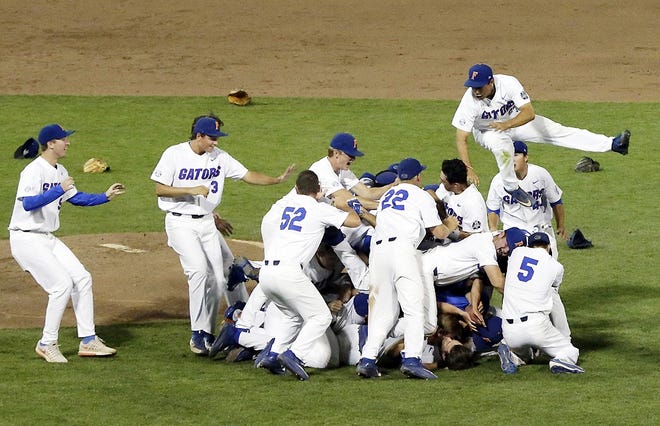Florida players celebrate after defeating LSU in Game 2 to win the NCAA College World Series baseball finals in Omaha, Neb., Tuesday. [NATI HARNICK/ASSOCIATED PRESS]