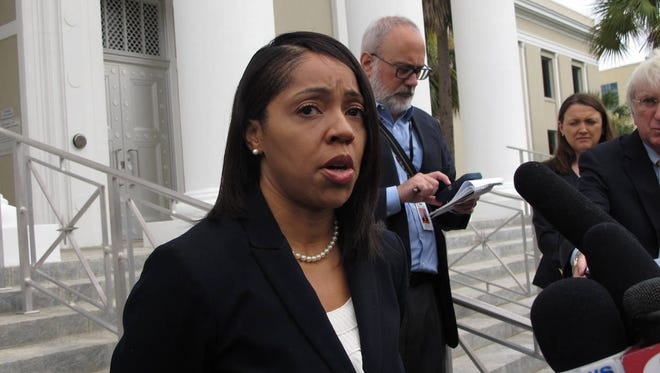 State Attorney Aramis Ayala talks to reporters after her lawyer asked the Florida Supreme Court to return 24 murders cases Gov. Rick Scott reassigned to another prosecutor. (Associated Press)