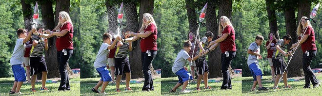 Trent Nickles (left) and Ian Morales, both sixth-graders, help instructor Stephanie Laskey launch a water-filled two-liter bottle rocket at Camp Invention held at Pfeiffer Intermediate School in Perry Township for kindergarten through sixth-garders this week. Watch video and view a photo gallery at IndeOnline.com.

(IndeOnline.com / Kevin Whitlock)