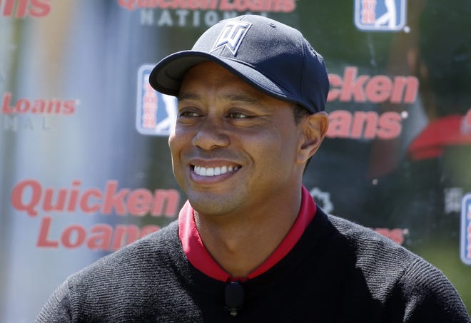 In this May 16, 2016 photo, Tiger Woods pauses during a Quicken Loans National golf tournament media availability on the 10th tee at Congressional Country Club, in Bethesda, Md. [AP Photo/Alex Brandon]