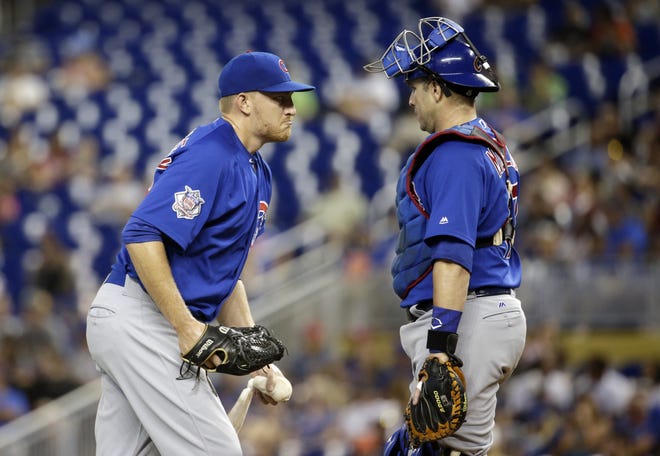Chicago Cubs starting pitcher Mike Montgomery, left, talks with catcher Miguel Montero during the first inning of a baseball game against the Miami Marlins on Sunday in Miami. [AP Photo/Lynne Sladky]