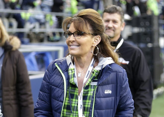 FILE- In this Dec. 15, 2016, file photo, Sarah Palin, political commentator and former governor of Alaska, walks on the sideline before an NFL football game between the Seattle Seahawks and the Los Angeles Rams in Seattle. Palin is accusing The New York Times of defamation over an editorial that linked one of her political action committee ads to the mass shooting that severely wounded then-Arizona Congressman Gabby Giffords, according to a lawsuit filed in Manhattan federal court on Tuesday, June 27, 2017. [AP Photo/Scott Eklund, File]