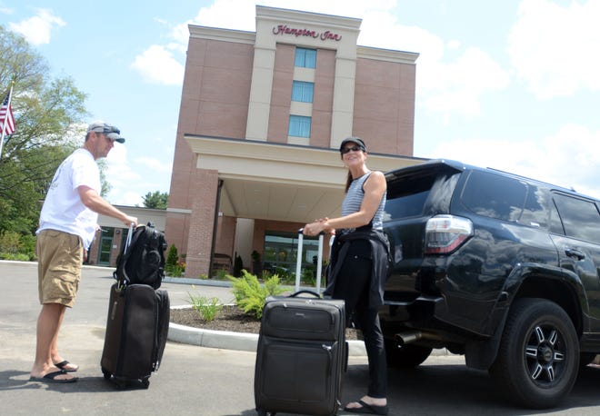Paul and Laurie Meyers from Omaha, Nebraska, unpack their car at the new Hampton Inn in Norwich Wednesday. They are in town to cheer on their son, Jake Meyers of the Tri-City Valley Cats as the team plays the Connecticut Tigers,

[Aaron Flaum/NorwichBulletin.com]