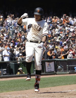 San Francisco Giants' Jae-Gyun Hwang, of South Korea, celebrates after hitting a solo home run against the Colorado Rockies during the sixth inning of a baseball game in San Francisco, Wednesday, June 28, 2017. (AP Photo/Jeff Chiu)