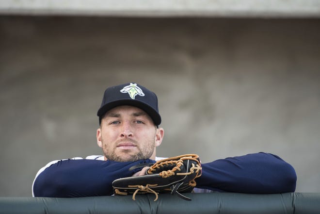 FILE- In this April 6, 2017, file photo, Columbia Fireflies outfielder Tim Tebow looks out from the dugout before the team's minor league baseball game against the Augusta GreenJackets in Columbia, S.C. Tebow has been promoted to the New York Mets' high Class A affiliate in St. Lucie, Fla. General manager Sandy Alderson announced the move before the Mets' 8-2 win at San Francisco on Sunday, June 25. (AP Photo/Sean Rayford, File)