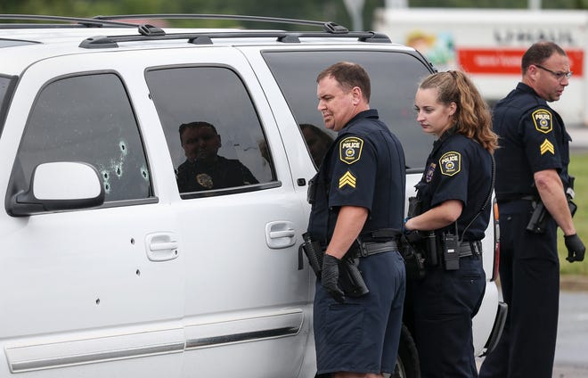 Police investigate a double shooting outside the Verizon Store on Brickton Road on June 26. A man and woman were shot in a white SUV and taken to a hospital with life-threatening injuries. The Columbia Police Department in response to recent gunplay will increase their presence around town. [Timothy Tai/Tribune]