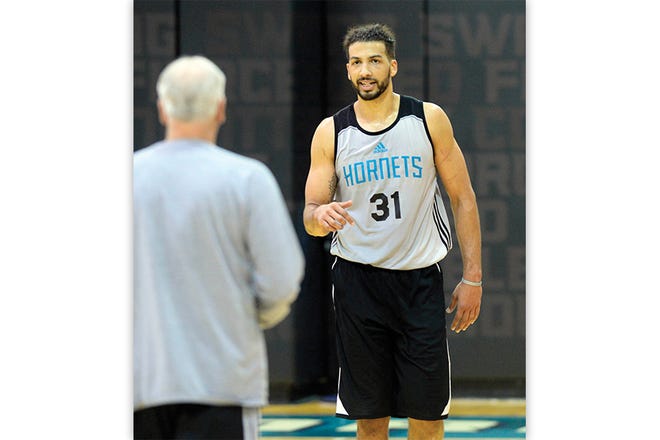 The Charlotte Hornets' Anthony Gill talks with assistant coach Bruce Kreutzer after practice at the Spectrum Center in Charlotte on Wednesday.