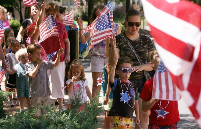 Children and chaperones march in a parade during an Independence Day Bash. [Gatehouse Media File]