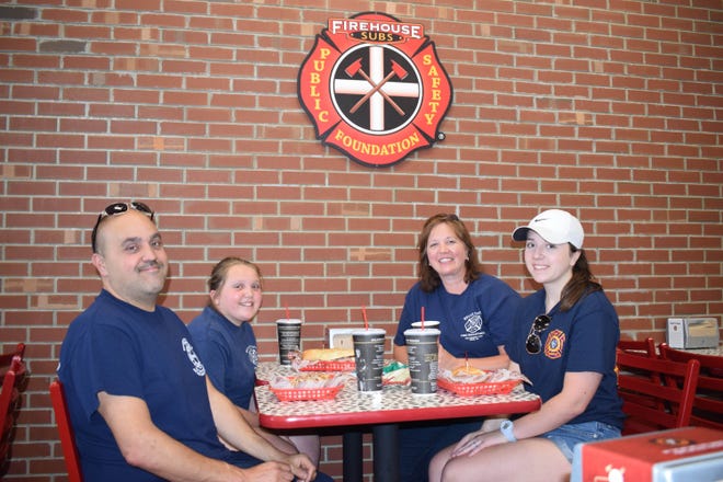 The Altadonna family — with Chris, left, Julia, Heather and Angelina Altadonna — grabs lunch at Firehouse Subs, 2203 W. 12th St. Chris Altadonna is also chief for the Belle Valley Volunteer Fire Department. [JENNIFER SMITH/CONTRIBUTED PHOTO]