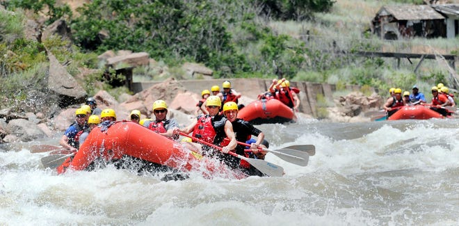 Rafts head into the Royal Gorge section of the Arkansas River during a summer commercial rafting trek. The challenging section of the river is open again now that flows are subsiding.