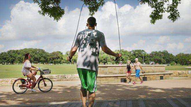 Kevin Pettus, visiting from St. Louis, works out jumping rope for his 50-minute routine in the partial shade of the Brent Grulke Plaza at Austin Vic Mathias Shores on Lady Bird Lake on June 13, 2017. RALPH BARRERA/AMERICAN-STATESMAN