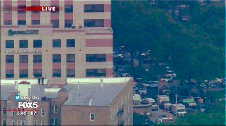 In this image taken from video provided by WNYW, police and other emergency personnel respond to Bronx Lebanon Hospital in New York after a gunman opened fire there on Friday, June 30, 2017. (WNYW via AP)
