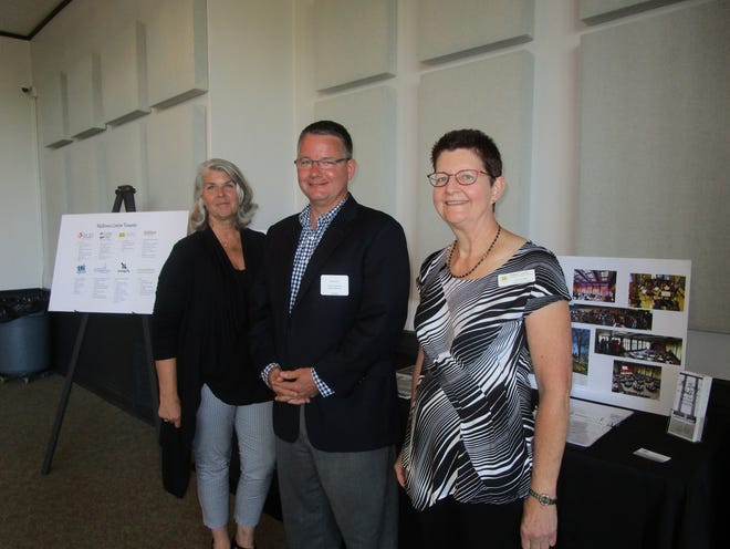 From left, Lori Gramer, general manager of the Holland Symphony Orchestra, Steve Grose, executive director of Jubilee Ministries, and Laurie Boer, Midtown Center director, are pictured at the ceremony Tuesday, June 27, at the Midtown Center. [Lori Timmer/Sentinel staff]