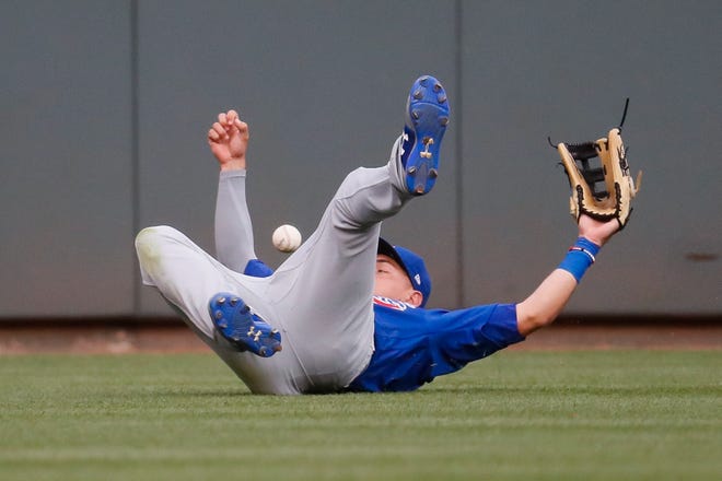 Chicago Cubs center fielder Albert Almora Jr. misses a double hit by Cincinnati Reds' Billy Hamilton in the fourth inning of a baseball game, Friday, June 30, 2017, in Cincinnati. (AP Photo/John Minchillo)