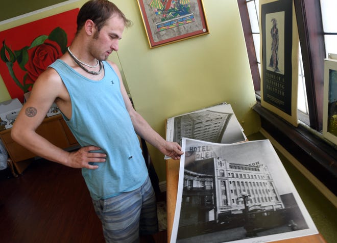 Alex Thompson looks at a photo of the Hotel Wolf, a historic building in downtown Stockton that will part of an exhibit at the Mexican Heritage Center. [CALIXTRO ROMIAS/THE RECORD]