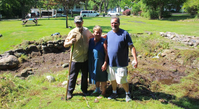 Cold Springs Park Committee Chair Ted Jansen with Hillsdale County Youth Home workers Renee Rudnik and Jack Beach during a work day in Cold Springs Park. [ANDREW KING PHOTO]