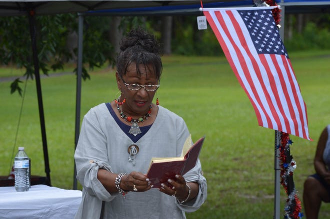 Keynote speaker Evangelist Clara Brown addresses the crowd during the Juneteenth ceremony held near the Georgetown Cemetery in Jacksonville Saturday morning. Juneteenth began in Texas when Maj. Gen. Gordon Granger of the United Army led his troops into the city of Galveston. There, on June 19, 1865, he officially proclaimed freedom for slaves in the state. For more photos from the observance, visit JDNews.com. [Alan Lane/The Daily News]