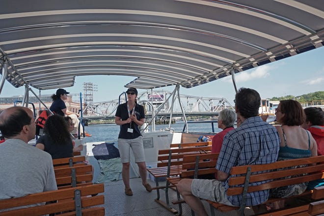 Sarah Arpie, of Mystic Aquarium, provides information about the history and biology of the Providence and Seekonk Rivers aboard the Blackstone Valley Explorer during a 45-minute tour on Saturday. The tours will continue for the next five weeks at 10 and 11 a.m. Saturdays and 1, 2 and 3 p.m. Sundays. More information at http://www.rivertourblackstone.com. [The Providence Journal / Sandor Bodo]