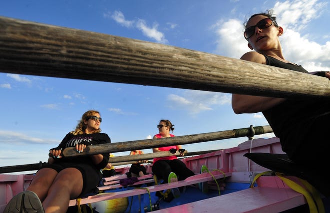 Brook Baptiste, Allison Francisco and Lara Harringtion in the boat "Faial" move along the waters of Clark's Cove prepping for the 9th International Azorean Whaleboat Regatta to be held in September. [DAVID W. OLIVEIRA/STANDARD-TIMES SPECIAL/SCMG]