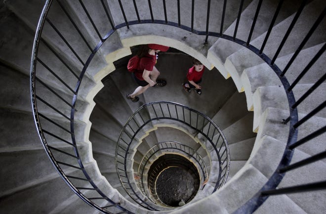 Wolfgang Dennewitz looks up to the top as he and his mom, Sarah, work their way up the circular staircase of the Miantonomi Tower in Newport. [The Providence Journal / Kris Craig]