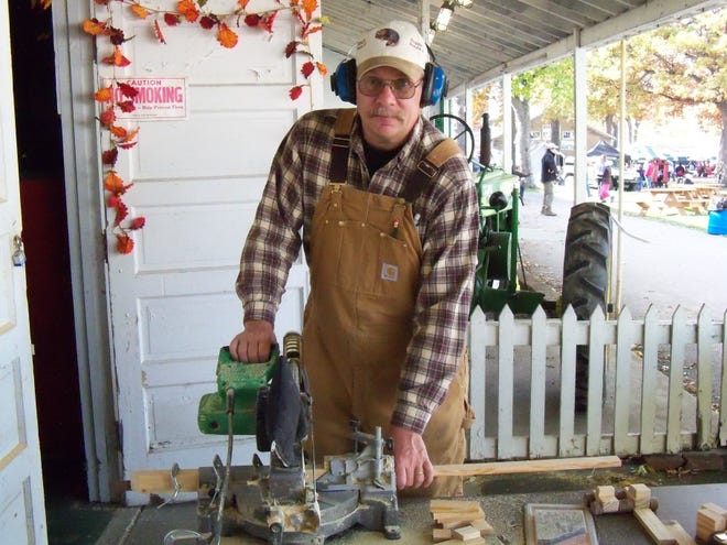 SUBMITTED PHOTO

Russ Riggle, owner of Possum Proudcts in Newcomerstown, has been handmaking wooden toys as a business venture for about five years. He markets and sells his toys — trains, trucks and planes — through area festivals and craft shows.