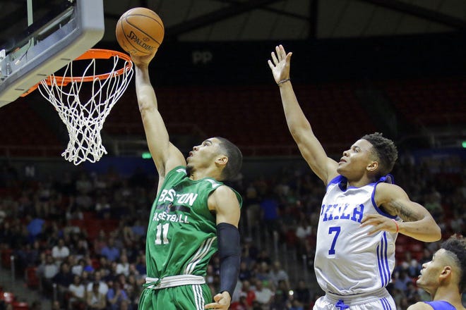 Boston Celtics forward Jayson Tatum goes up for a layup as Philadelphia 76ers guard Markelle Fultz defends during the second half of an NBA summer league basketball game Monday in Salt Lake City.