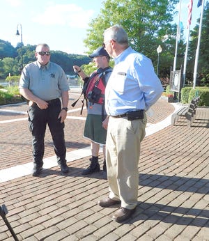 Mike Masi and Rob Parese, Little Falls' police and fire chief, respectively, and Herkimer County Sheriff Chris Farber (from left) confer at Rotary Park Monday afternoon near the command center for their Erie Canal search-and-rescue mission.     

[Donna Thompson/Times Telegram]