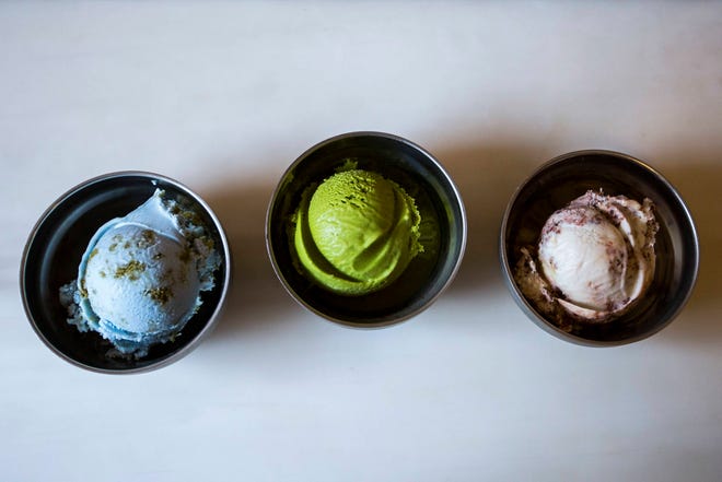 In this June 21, 2017 photo, three flavors of vegan ice cream - from left, Planet Earth, Matcha Green Tea, and Toasted Coconut Brownie Sundae - are on display at a Van Leeuwen shop in the Brooklyn borough of New York. Van Leeuwen serves both dairy and non-dairy artisan ice cream at five shops in New York and three in Los Angeles — and business is booming. (AP Photo/Michael Noble Jr.)