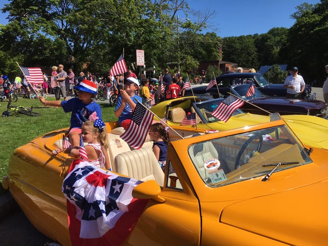 Madeleine Mazer, Zachary Mazer, Ben Roge and Sami Roge get ready for the Independence Day parade in a 1948 Hudson.