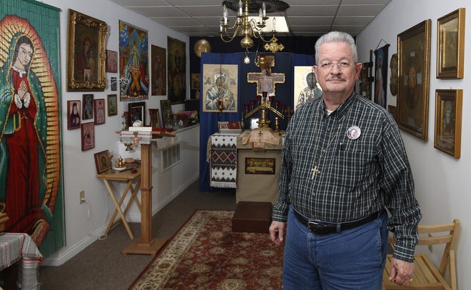 When the Rev. Michael Kirkland found a storefront for his bail bonds business, the first thing he added was a chapel. The Greek Orthodox priest said he prays for all the criminals he posts bond for. [Tom Dodge/Dispatch]