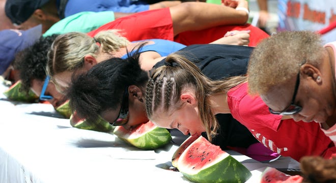 Contestents compete in the watermelon eating contest during the Gastonia July 4th Festival Tuesday. [JOHN CLARK/THE GASTON GAZETTE]