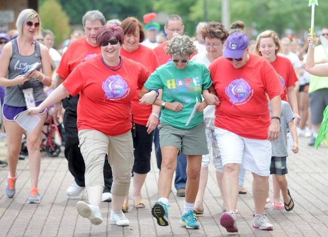 Massillon Relay for Life co-chairs Mary Kay Butler (second row, left) and Lorna Hill (second row, right) accompany participants at last year's event. (Submitted photo)