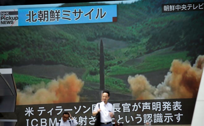 A public TV screen broadcasts a local TV news showing what was said to be the launch of a Hwasong-14 intercontinental ballistic missile, ICBM, aired by North Korea's KRT on July 4, 2017, in Tokyo Wednesday, July 5, 2017. The Japanese government says it is taking every measure to ensure people's safety a day after North Korea test-launched an intercontinental ballistic missile. The missile that North Korea launched Tuesday fell into the sea between the Korean Peninsula and Japan. (AP Photo/Eugene Hoshiko)