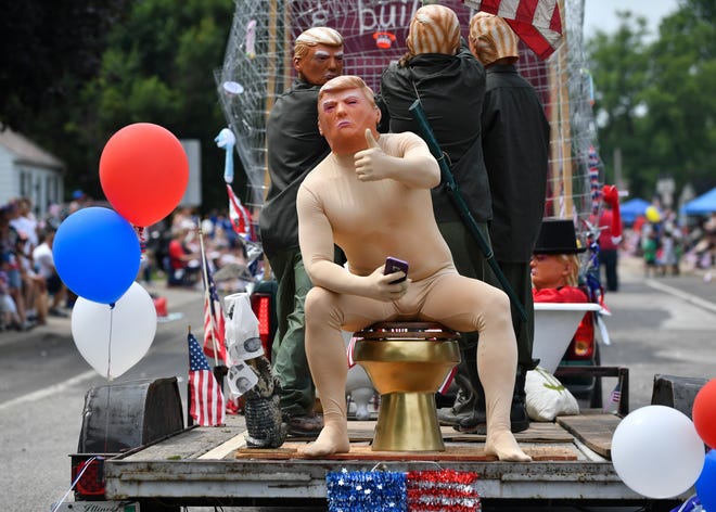 RON JOHNSON/JOURNAL STAR A float with costumed President Donald Trump characters travels down the West Peoria Fourth of July Parade route on Tuesday.