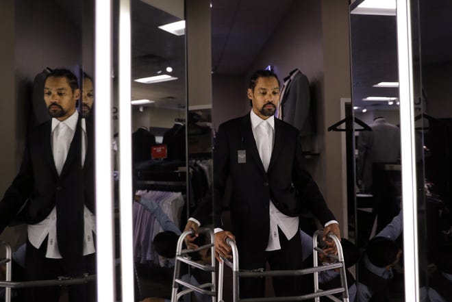 Jamie Nieto, a two-time Olympic high jumper who is recovering from a spinal cord injury he suffered 14 months ago after a mistimed backflip, looks in the mirror while getting his tuxedo fitted ahead of his July wedding. [JAE C. HONG/AP PHOTO]