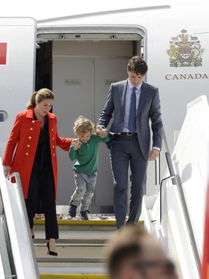 Sophie Gregoire-Trudeau, son Hadrien, and Canada's Prime Minister Justin Trudeau, from left, arrive for the G-20 summit in Hamburg, northern Germany, Thursday, July 6, 2017. The leaders of the group of 20 meet July 7 and 8. [AP Photo/Michael Sohn]