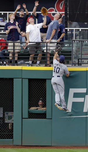 San Diego outfielder Hunter Renfroe climbs the wall at Progressive Field in Cleveland but comes up well short of preventing a two-run home by the Tribe's Jose Ramirez in the first inning Thursday night. [Tony Dejak/The Associated Press]