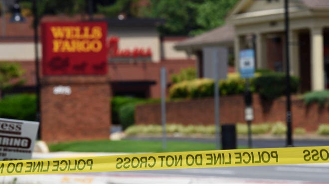 Police tape blocks the entrance to a Wells Fargo Bank on Friday in Marietta, Ga. (Associated Press)