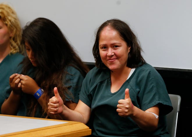 Isabel Martinez gestures towards news cameras during her first court appearance Friday, July 7, 2017, in Lawrenceville , Ga. Martinez is charged with killing four of her children and their father. (AP Photo/John Bazemore)
