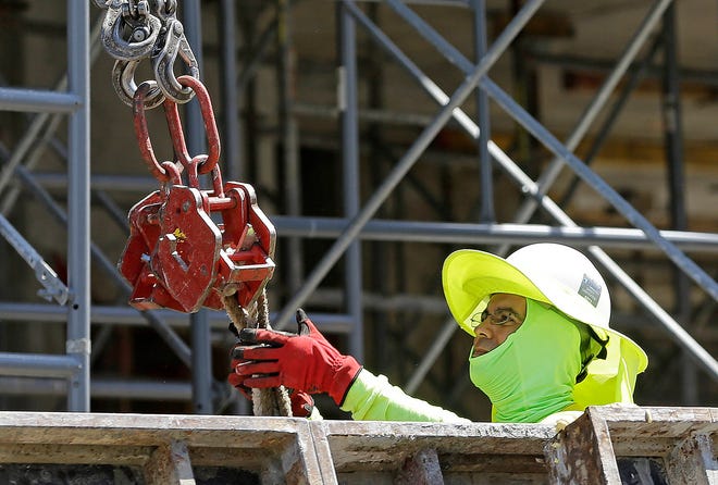 In this Thursday, June 15, 2017, photo, a construction worker continues work on a condominium project in Coral Gables, Fla. On Friday, July 7, 2017, the Labor Department released the U.S. jobs report for June. (AP Photo/Alan Diaz)
