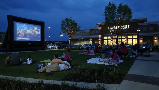 Children and adults watch the animated film Minions at the first Screen on the Green movie event of the summer at Midtown Village in Tuscaloosa, Alabama, on Saturday July 9, 2016. [Staff Photo/Erin Nelson]