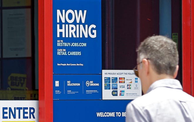 In this Monday, May 22, 2017, photo, a “Now Hiring” sign welcomes a customer entering a Best Buy store in Hialeah, Fla. U.S. employers added a robust 222,000 jobs in June, the most in four months, a reassuring sign that businesses may be confident enough to keep hiring despite a slow-growing economy. (AP Photo/Alan Diaz)