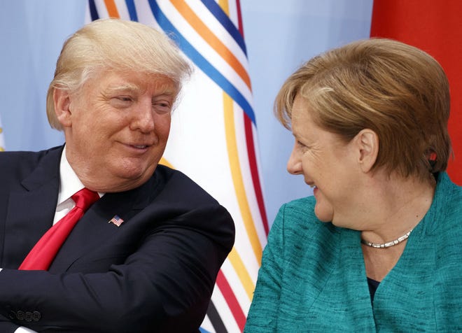 President Donald Trump talks with German Chancellor Angela Merkel during the Women's Entrepreneurship Finance event at the G20 Summit, in Hamburg, Germany, on Saturday, July 8, 2017.