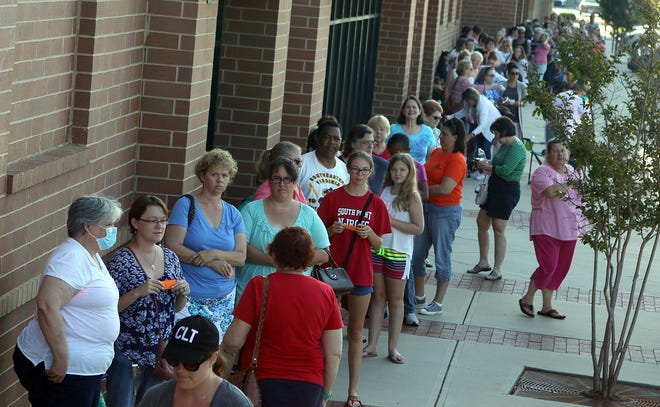 Hundreds of people wait in line for the Girls Day Out sales event at Mary Jo's Cloth Store on Cox Road early Saturday morning, July 8, 2017. [Mike Hensdill/The Gaston Gazette]