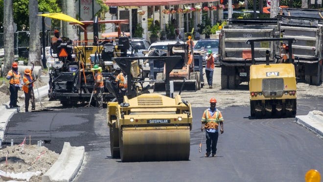 Paving is underway on the westbound lanes of the Flagler Memorial Bridge on the Palm Beach side, as the replacement bridge inches toward completion. (Lannis Waters / Daily News)