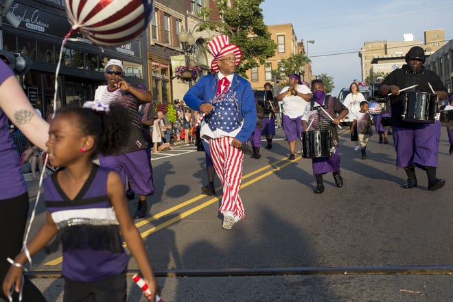 Charles Strickland dances as he marches with Youth Against Violence Organization on Tuesday, July 4, 2017, during the 54th annual Fourth of July parade in downtown Rockford. [MAX GERSH/RRSTAR.COM STAFF]