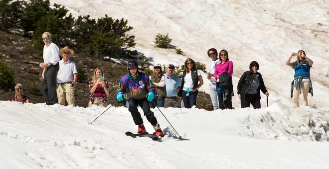 In this July 5, 2017 photo, Skier George Jedenoff celebrates his 100th birthday with a couple of ski runs down Chip’s Run from the top of the Peruvian Lift at Snowbird Resort, Utah, surrounded by friends and family. (Leah Hogsten/The Salt Lake Tribune via AP)