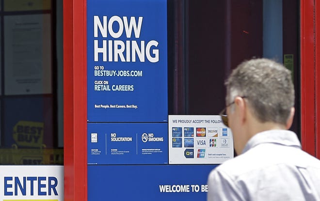 A "Now Hiring" sign welcomes a customer entering a Best Buy store in Hialeah, Fla, on Monday, May 22. U.S. employers added a robust 222,000 jobs in June, the most in four months, a reassuring sign that businesses may be confident enough to keep hiring despite a slow-growing economy. [AP Photo/Alan Diaz]