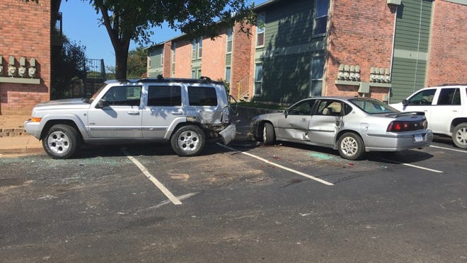 Two damaged vehicles can be seen Sunday morning in the parking lot of the Pleasant Hill Apartments RACHEL RICE // AUSTIN AMERICAN-STATESMAN