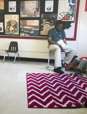 This 2015 photograph of first-year kindergarten teacher Stanley Watkins appearing to be asleep while supervising young children was used by the Columbus school district as evidence against him in the process of firing him. [Columbus City Schools]